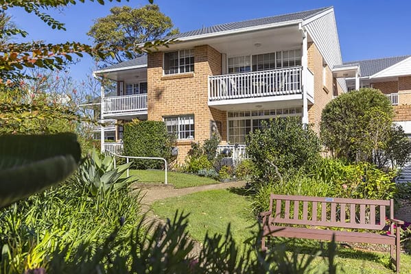 Exterior view of a retirement village with gardens