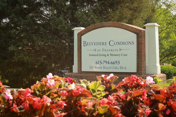 Sign for Belvedere Commons of Franklin amid flowers