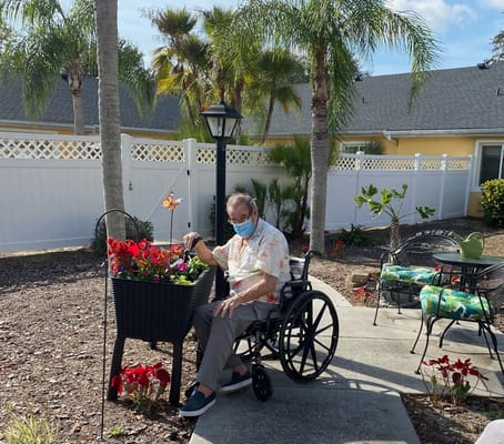 A resident gardening in the outdoor space