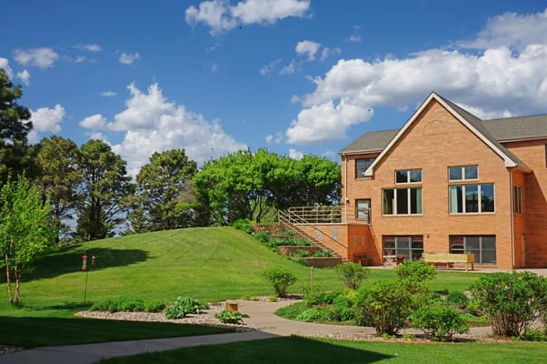 Exterior view of a senior living facility with green landscaping