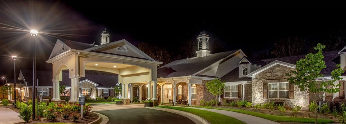 Exterior view of a senior living facility at night