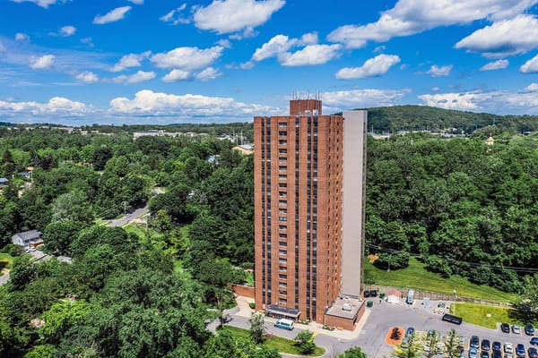 Aerial view of a nursing home building surrounded by greenery