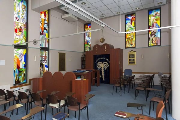 Interior view of a facility's common area with stained glass windows