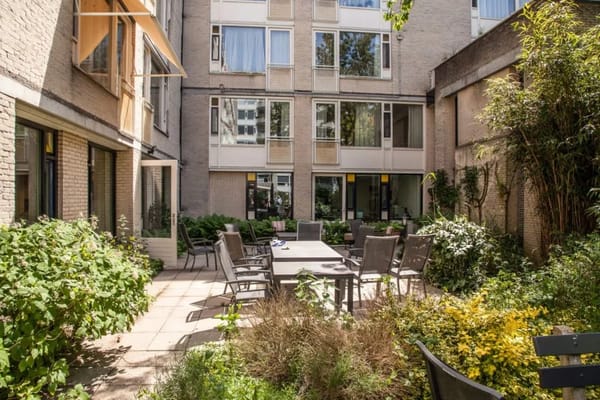Outdoor courtyard with seating and greenery at Beth Shalom.