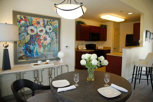 Cozy dining area with decorative artwork and flowers