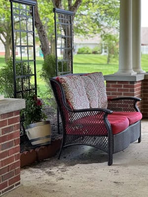 A cozy outdoor seating area with a garden view