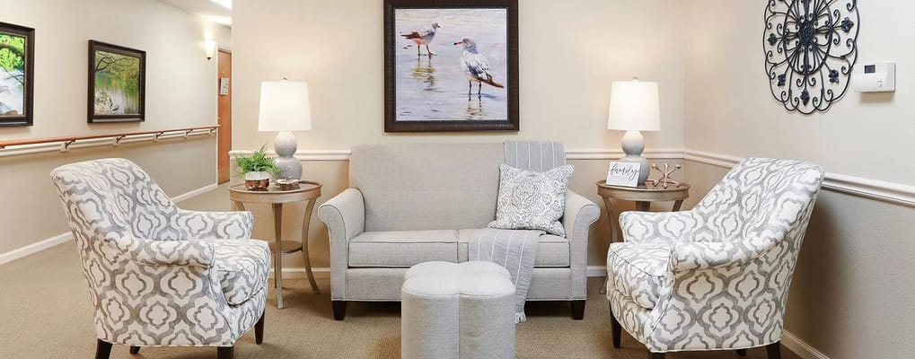 Comfortable seating area with decor in a facility hallway