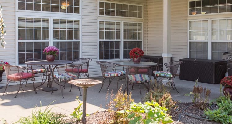 Outdoor patio area with tables and flowers