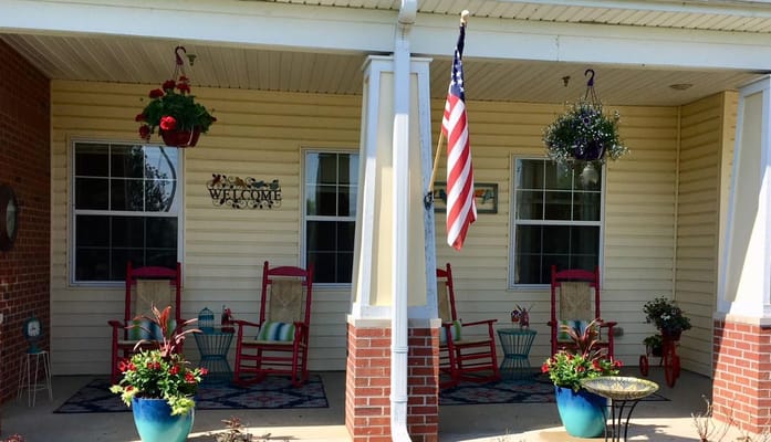 Welcoming outdoor area with rocking chairs and flowers