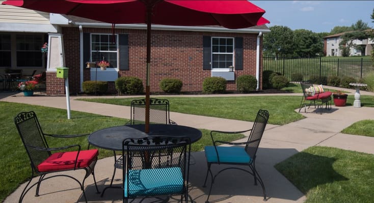 Outdoor seating area with tables and umbrellas