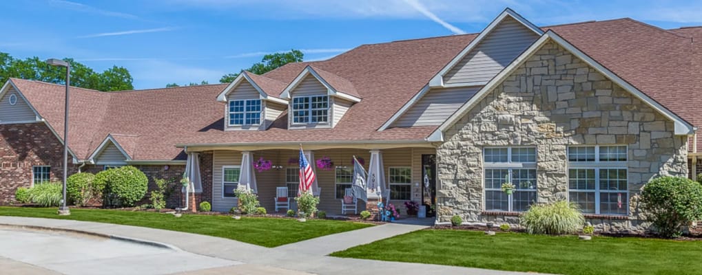 Building exterior of Bickford of Urbandale with entrance and flags