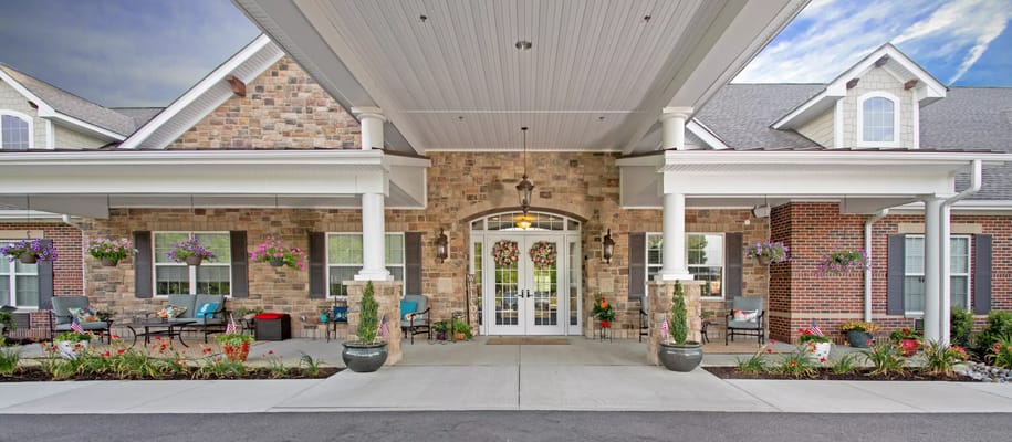 Front entrance of a senior living facility with gardens