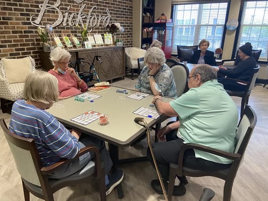 Residents engaged in a game activity in a common area