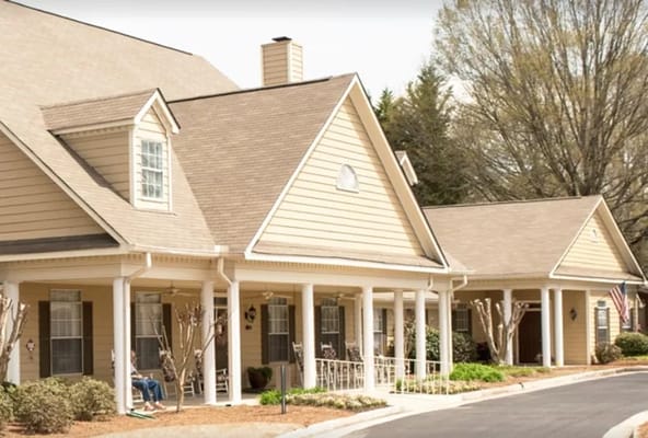 Exterior view of a senior living facility with porches