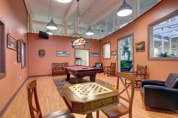 Common area with a pool table and seating