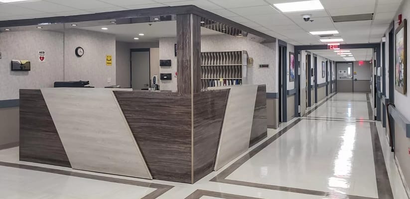 Reception area featuring a modern front desk and hallway.