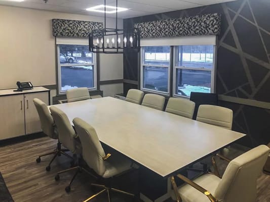 Spacious conference room with a large table and modern chairs