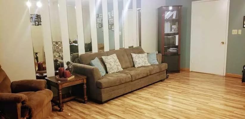 Cozy common area with a sofa and wooden floor