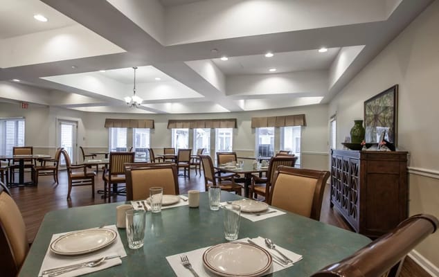 Bright dining room with tables set for meals