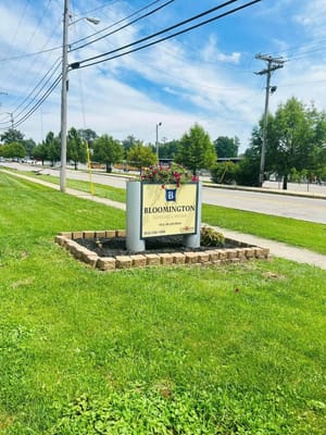 Sign for Bloomington Nursing & Rehabilitation Center with flower planter