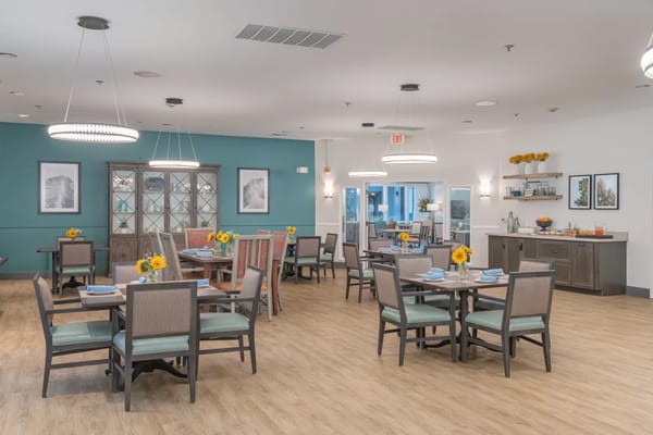 Bright dining room with tables set for meals