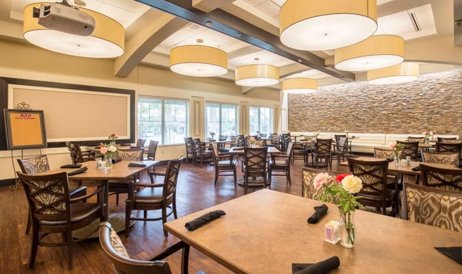 Bright dining area with tables and flowers