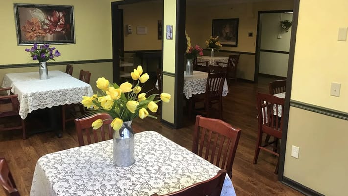 Bright dining room with floral table arrangements