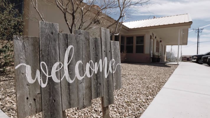 Outdoor welcome sign at the facility's entrance