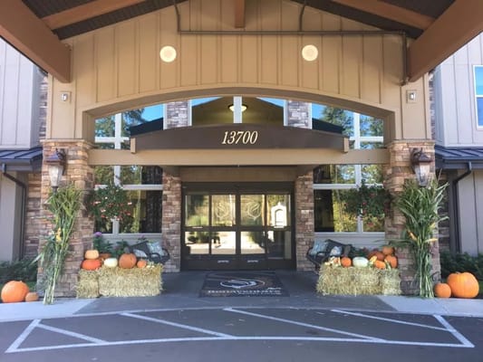 Exterior view of the facility entrance decorated for fall