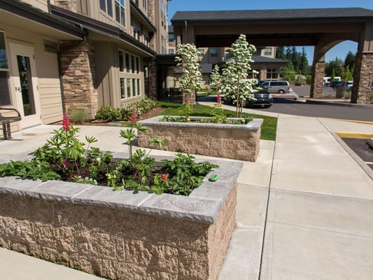 Entrance garden with flowers and the facility's exterior
