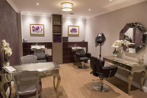Beauty salon with styling stations and floral decor