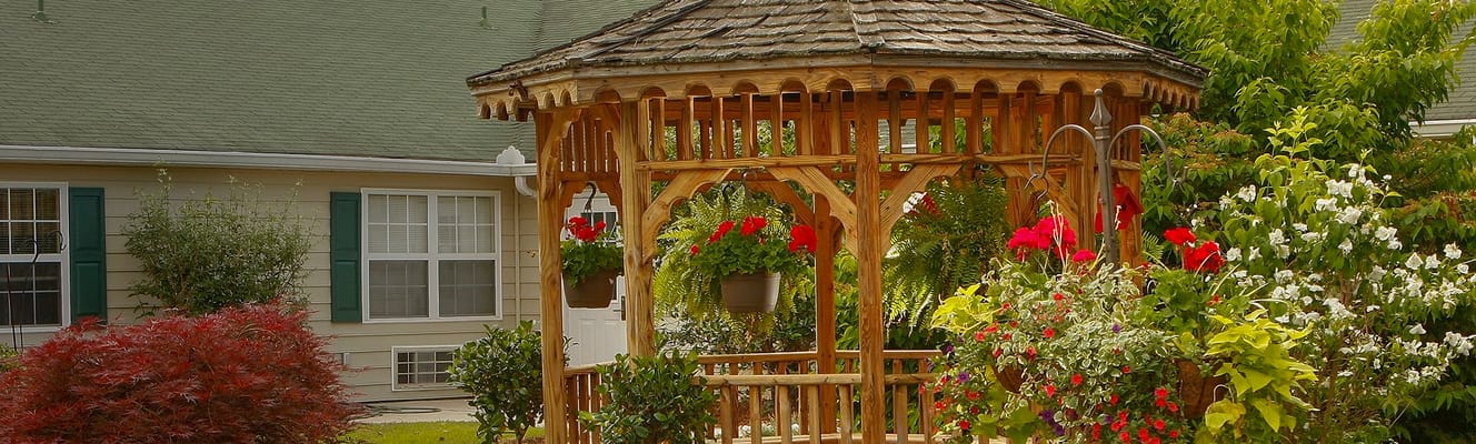 Outdoor gazebo surrounded by flowers in a garden