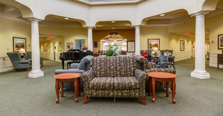 Common area with seating, piano, and residents