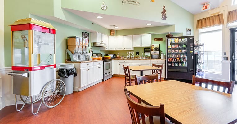 Interior view of a dining area with snack cart and vending machine