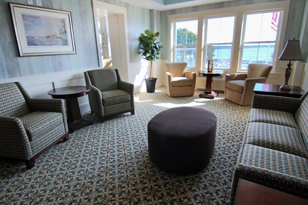 Bright common area with seating and large windows