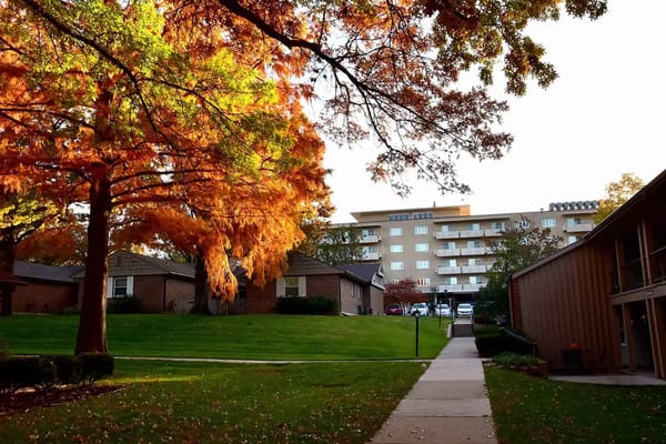 Pathway leading to a senior living facility surrounded by trees