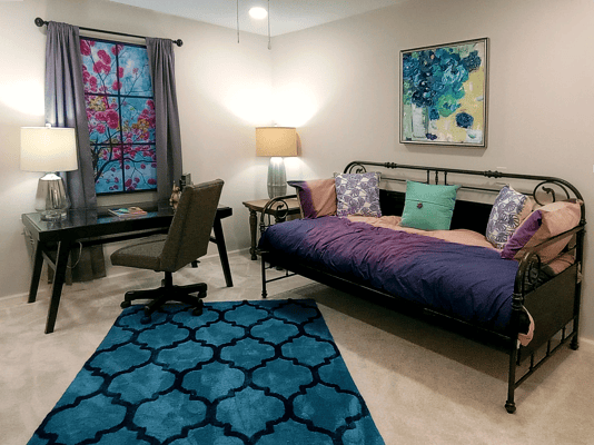 Cozy resident room with a daybed and desk