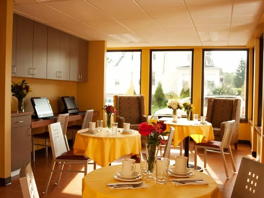 Bright dining area with tables set for a meal