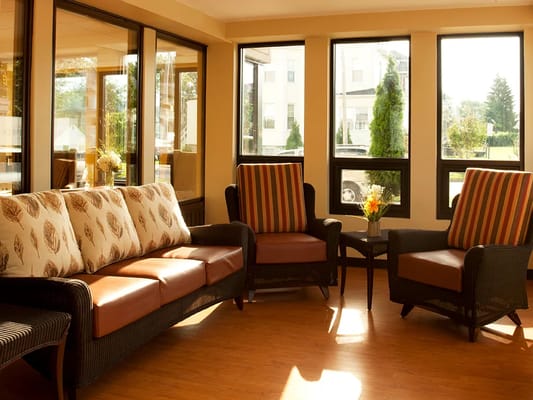 Bright common area with comfortable seating and large windows