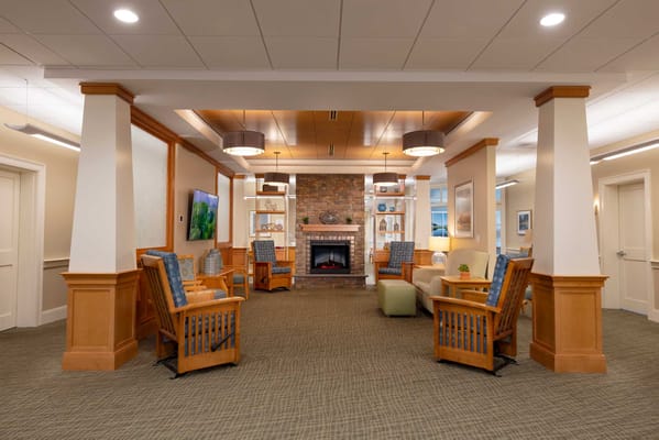 Cozy interior common area with seating and a fireplace