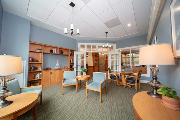 Bright interior of a common area with seating and bookshelves
