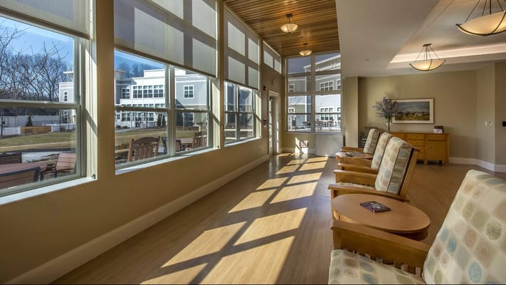 Bright common area with large windows and seating
