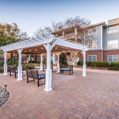Outdoor seating under a pergola at the facility