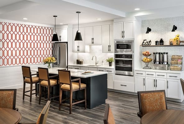 Bright kitchen area with seating and food displays