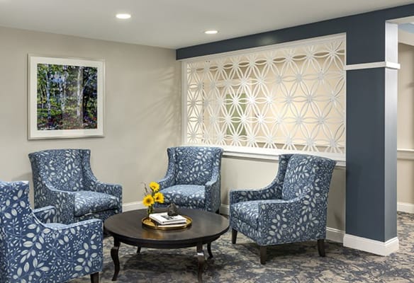 Bright and welcoming lounge area with blue chairs