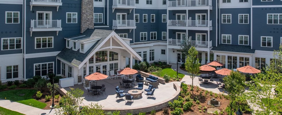 Aerial view of an outdoor social area with seating and gardens
