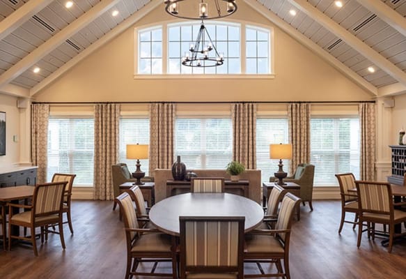 Bright common area with large windows and seating