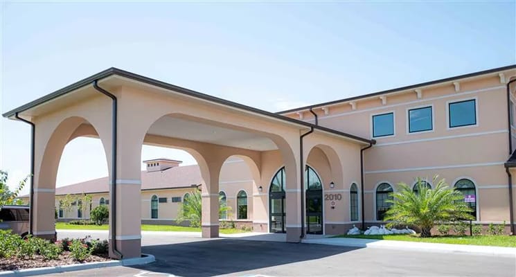 Front entrance of a senior living facility with arches