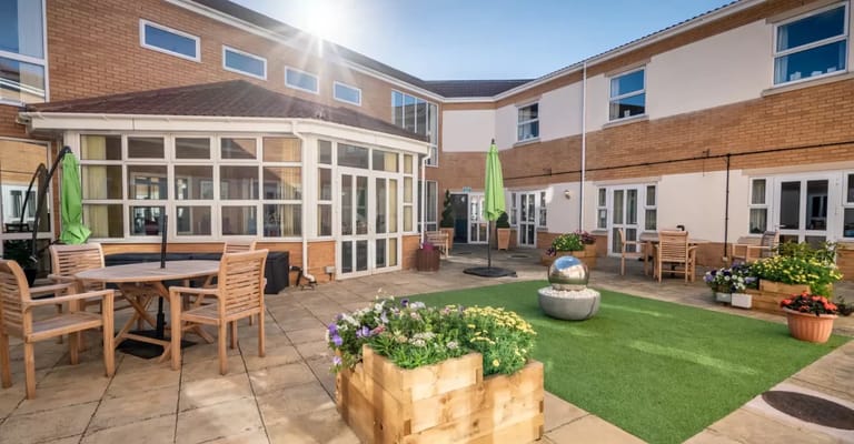 Outdoor patio area with seating and flowers