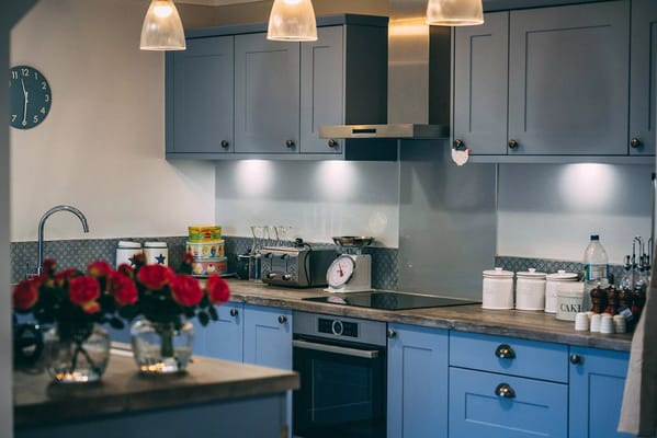 Bright kitchen with blue cabinets and flowers